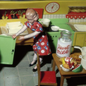 Woman Opening Refrigerator/ Milk in the Middle