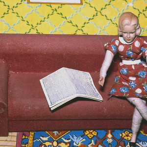 Woman/ Red Couch/ Newspaper